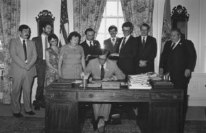 Photograph of Del. Governor Pierre S. (Pete) signing into law a bill making broadened capital ownership and employee stock ownership plans (ESOPs) official policy to be encouraged by all agencies of the State of Delaware. Legislative Hall, Dover, Delaware, June 22, 1981.